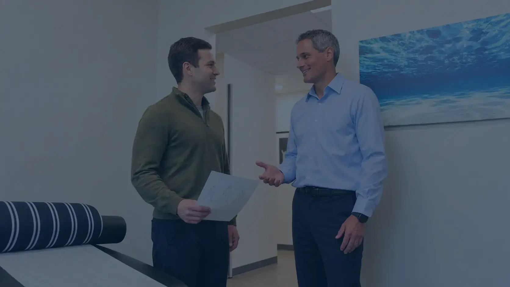 Dr. Penner handing a patient a home exercise plan at the end of a visit at SoundCare Chiropractic in Woodinville